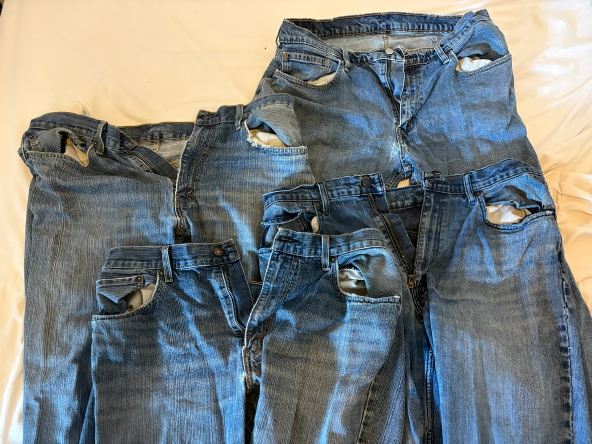 Denim: four pairs of men’s jeans in various states of disrepair