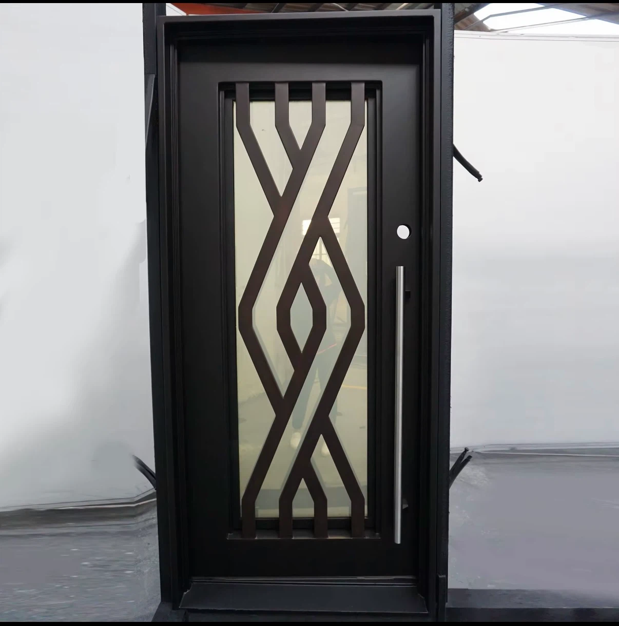 Wrough iron entry door with decorative glass panel