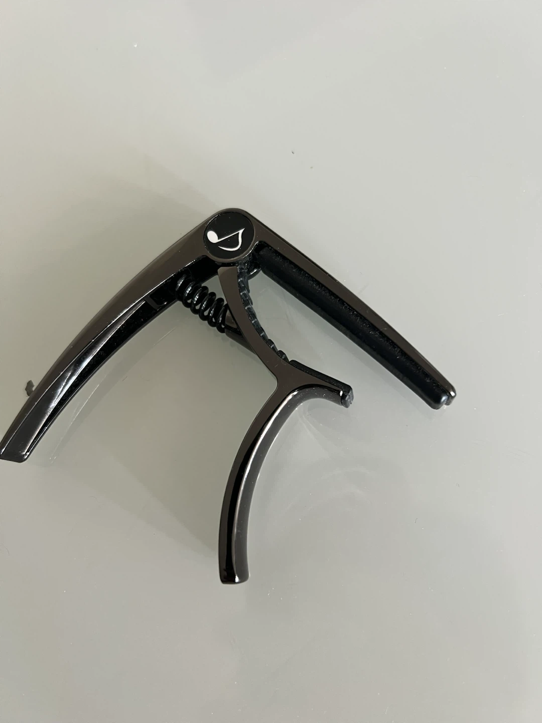 Dark Grey Guitar Capo with Musical Note Logo
