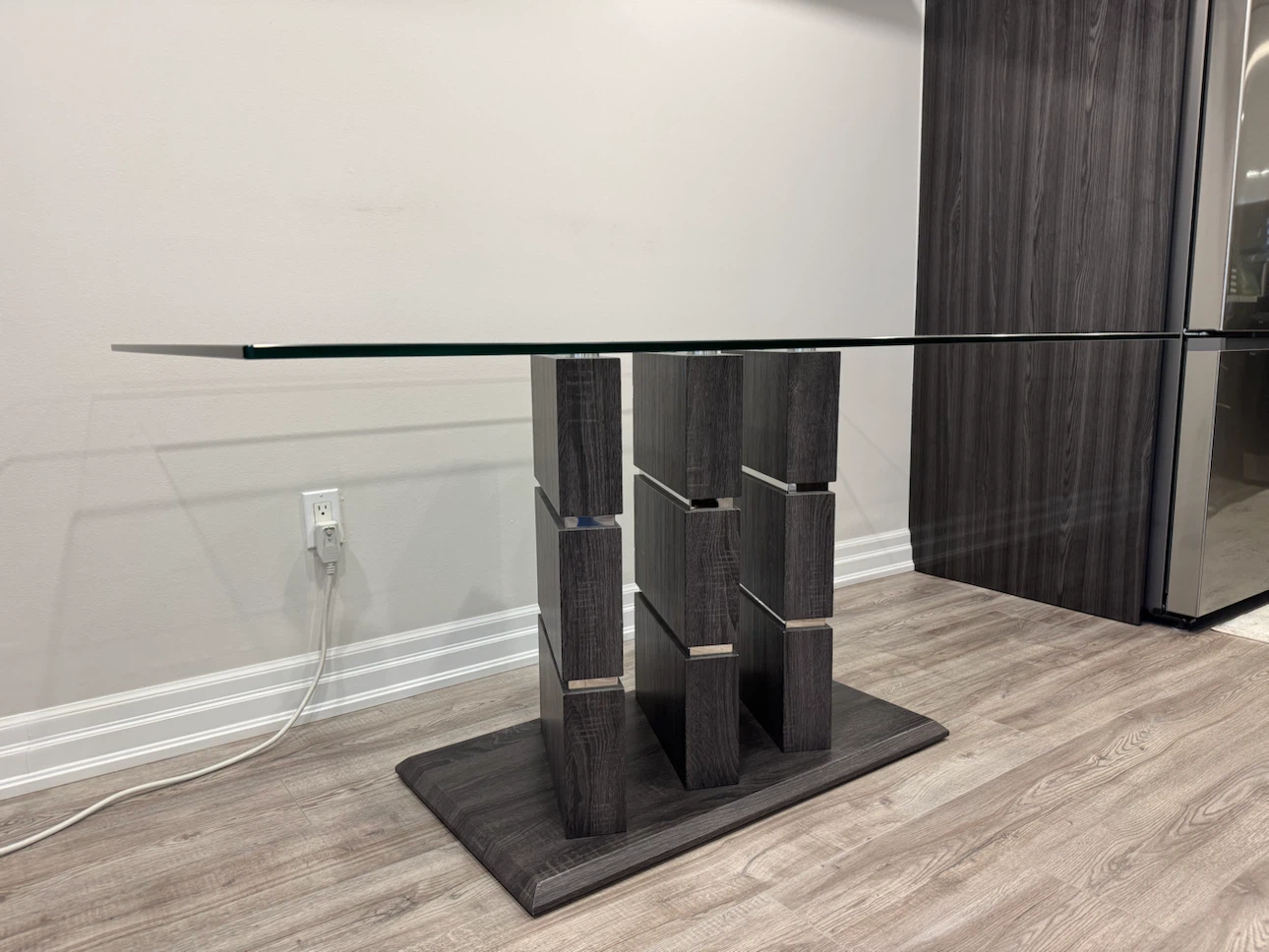 Dining table with a clear glass top and a solid wooden base - photo 3