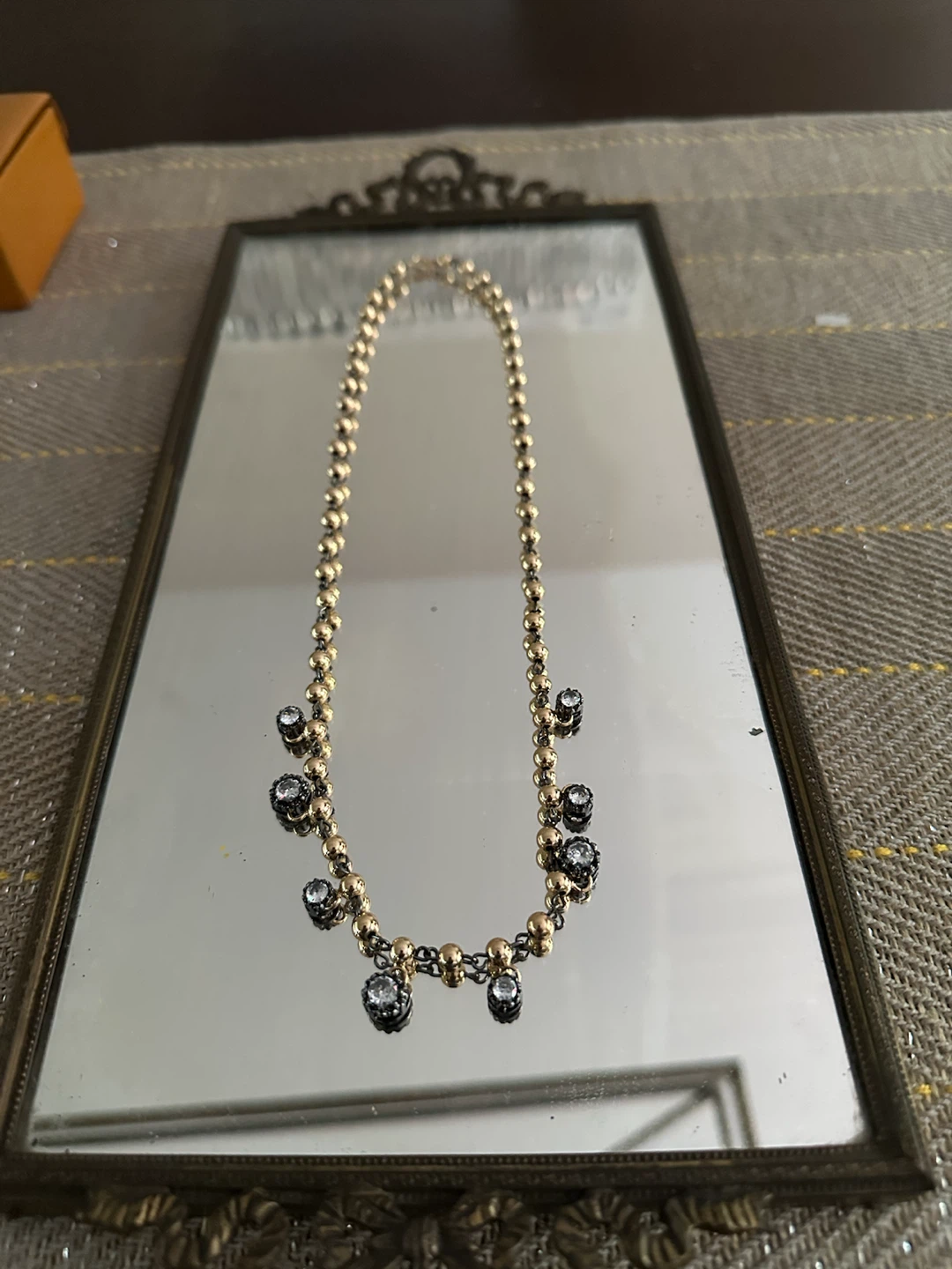 Gold beaded necklace with clear stones
