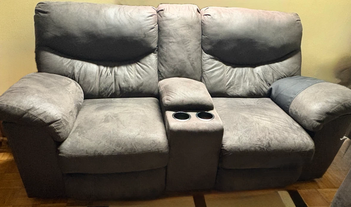 Ashley love seat recliner with hand rest and 2 cup holders
