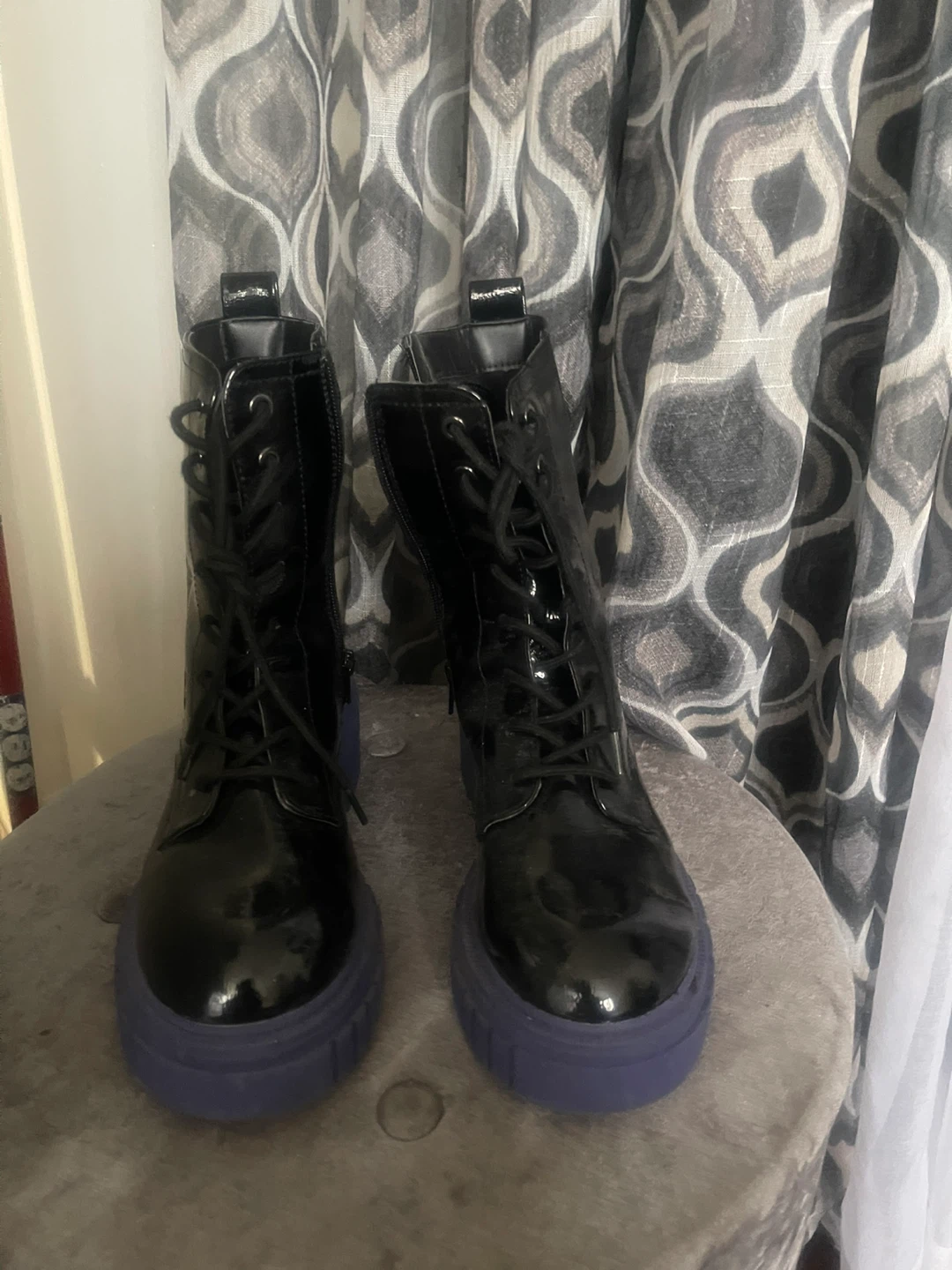 Black patent lace-up boots with purple sole