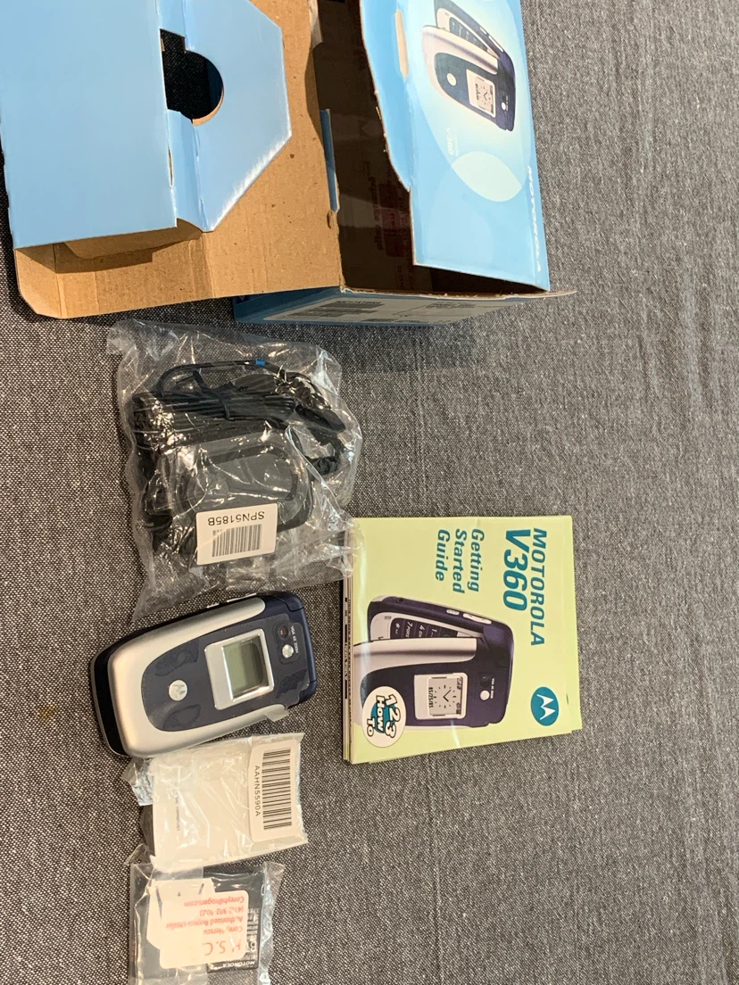 vintage Motorola V360 clamshell mobile phone in silver and blue