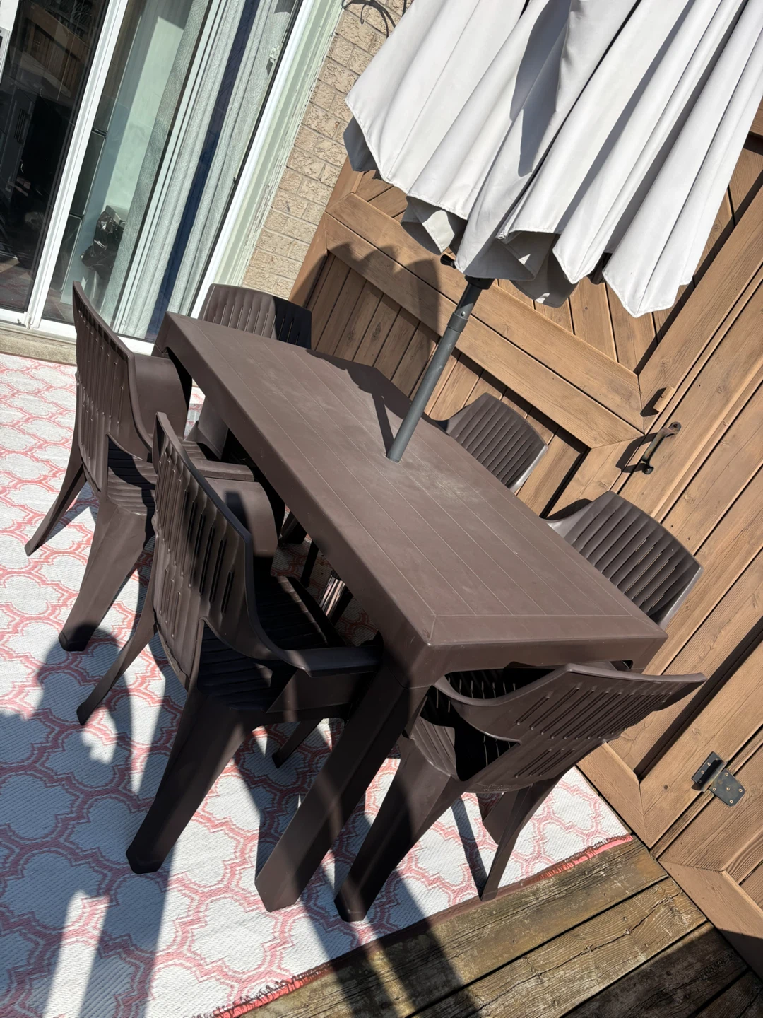 Backyard table set with chairs and umbrella and the marble base