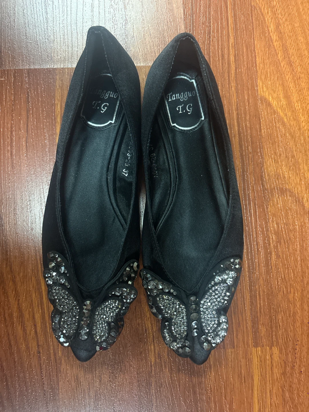 Black flats with butterfly embellishment
