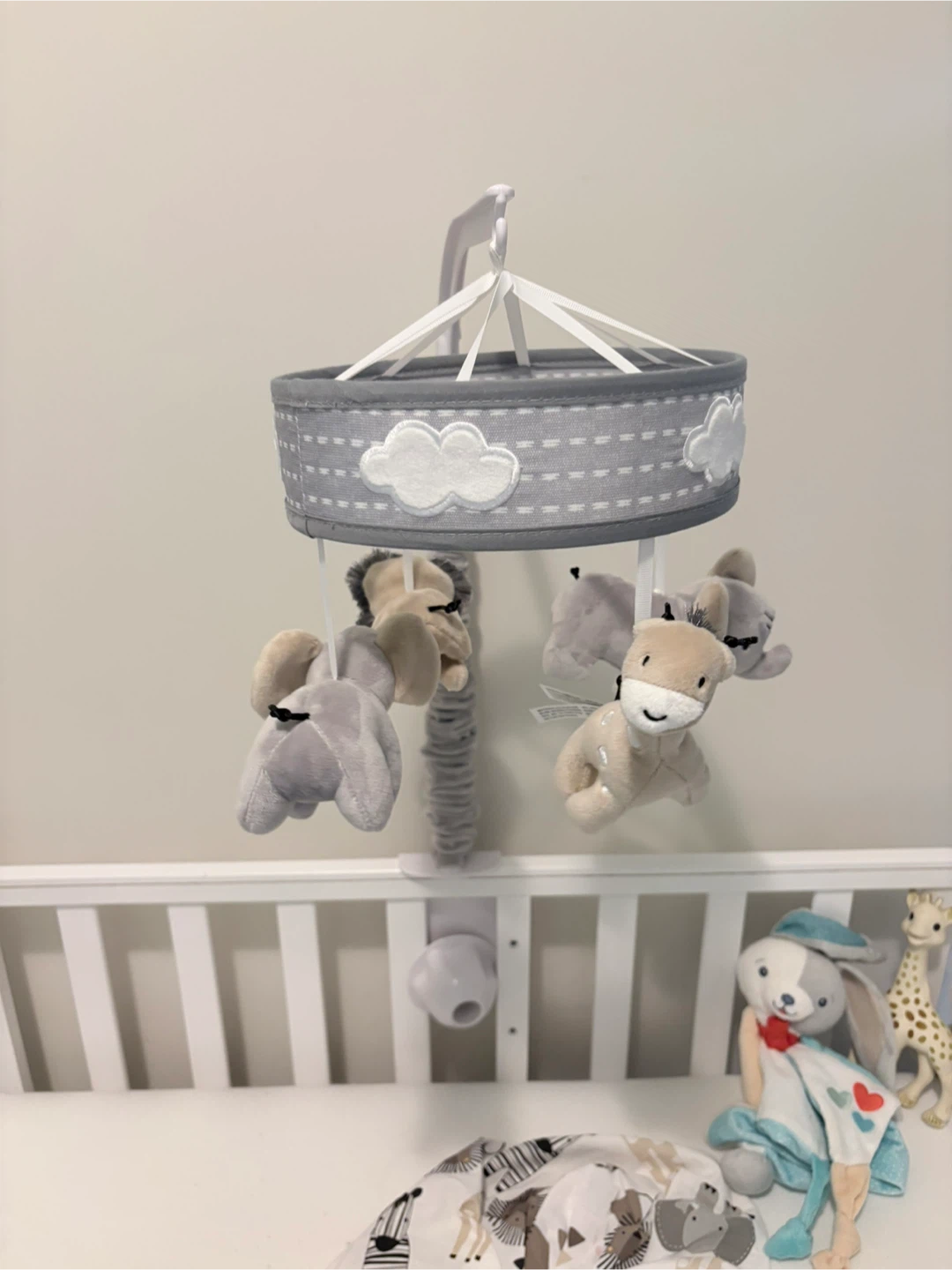 Adjustable size baby cot with  stuff animals and baby mobile
