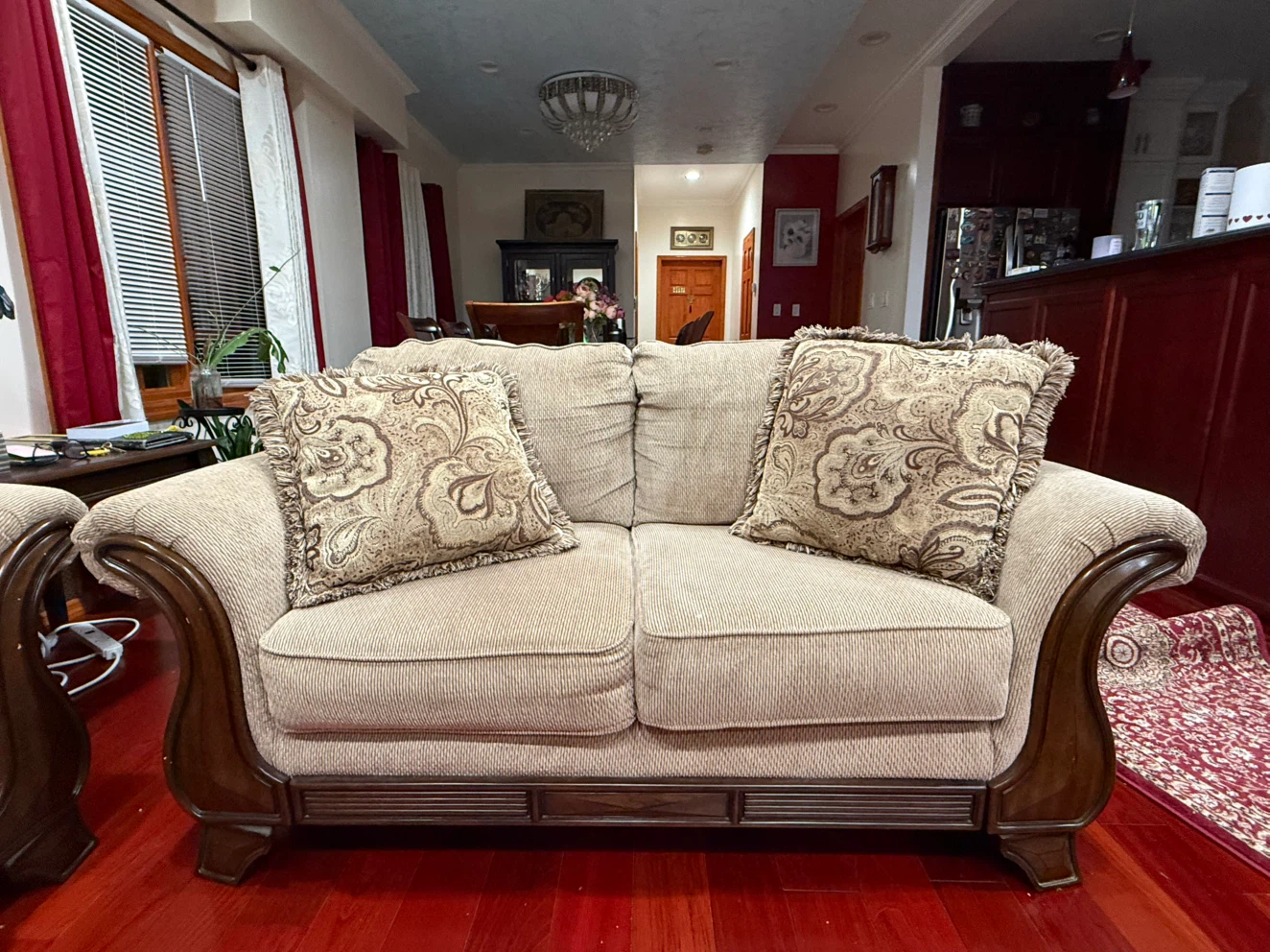 Beige Loveseat with Scroll Arms and Decorative Pillows