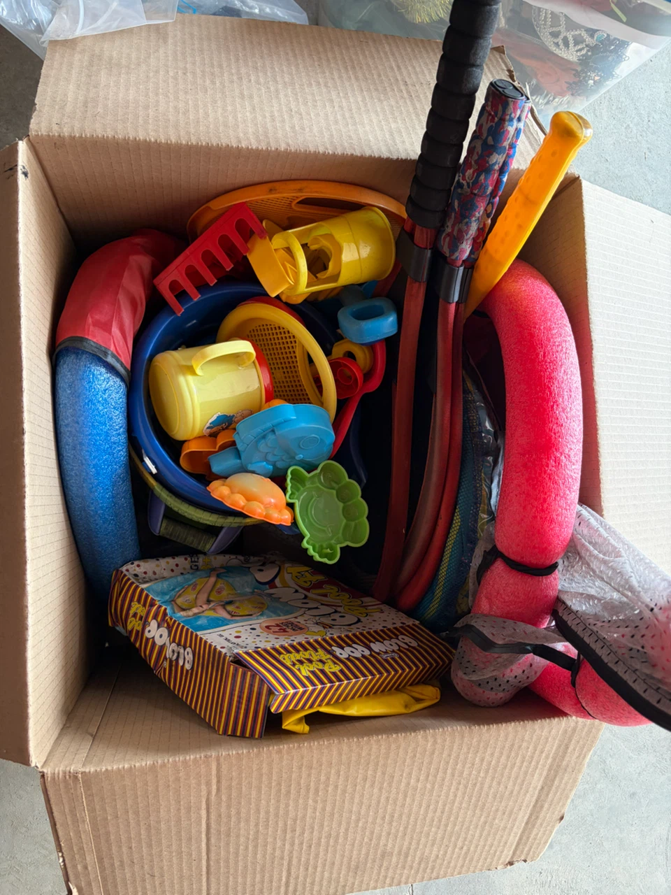 Box of assorted beach and pool toys
