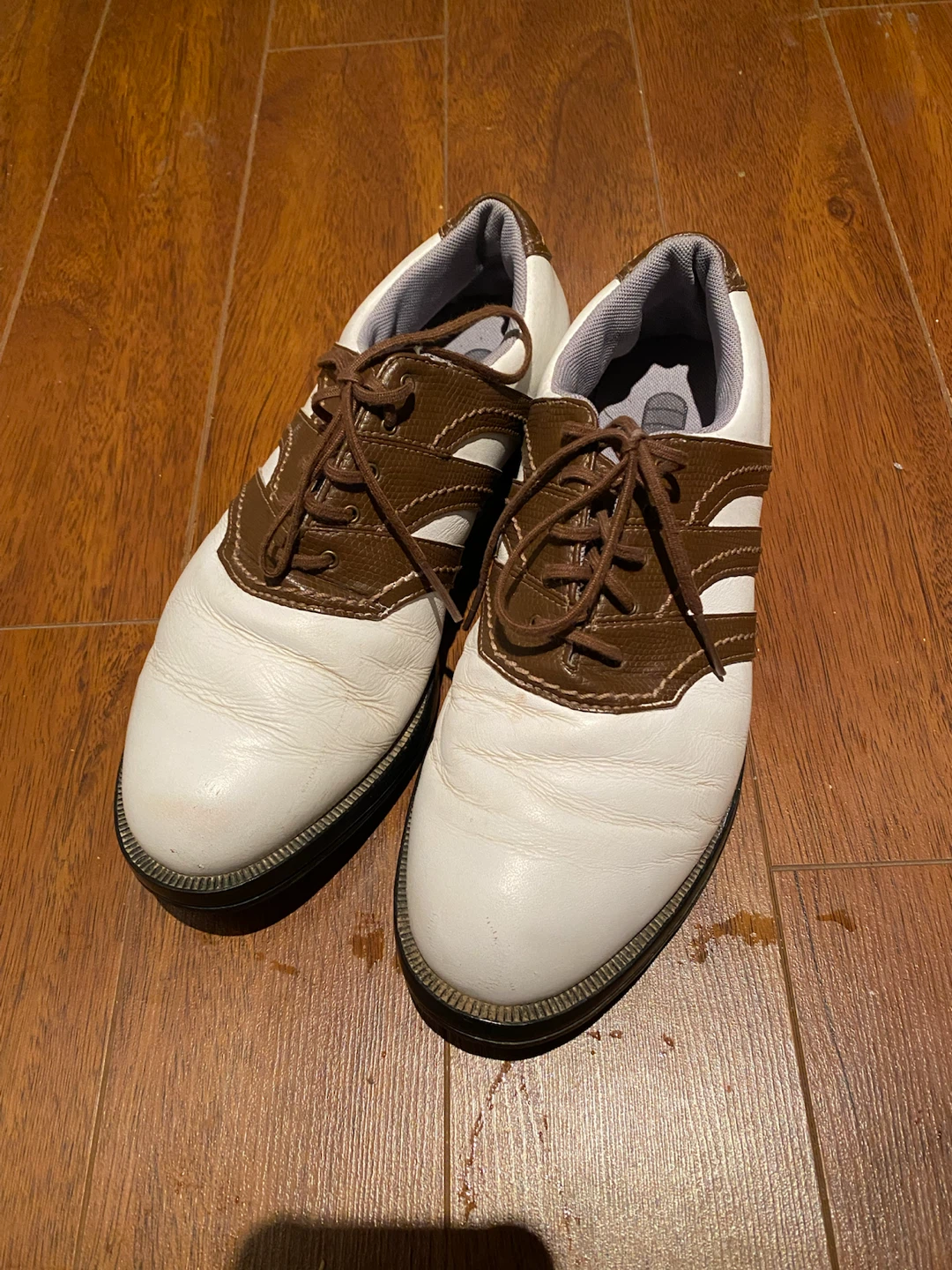 White and brown golf shoes