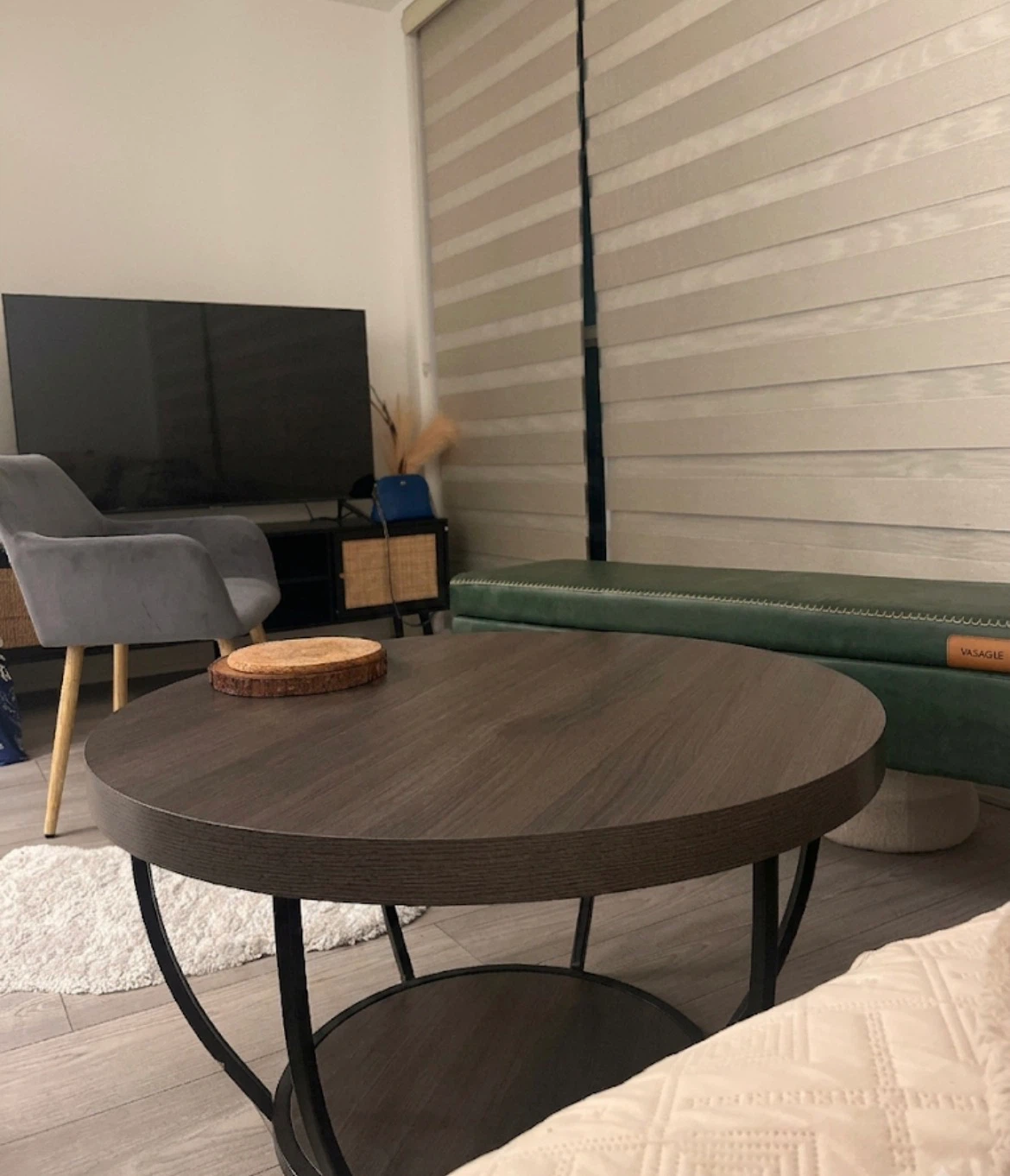 Round coffee table with dark wood finish