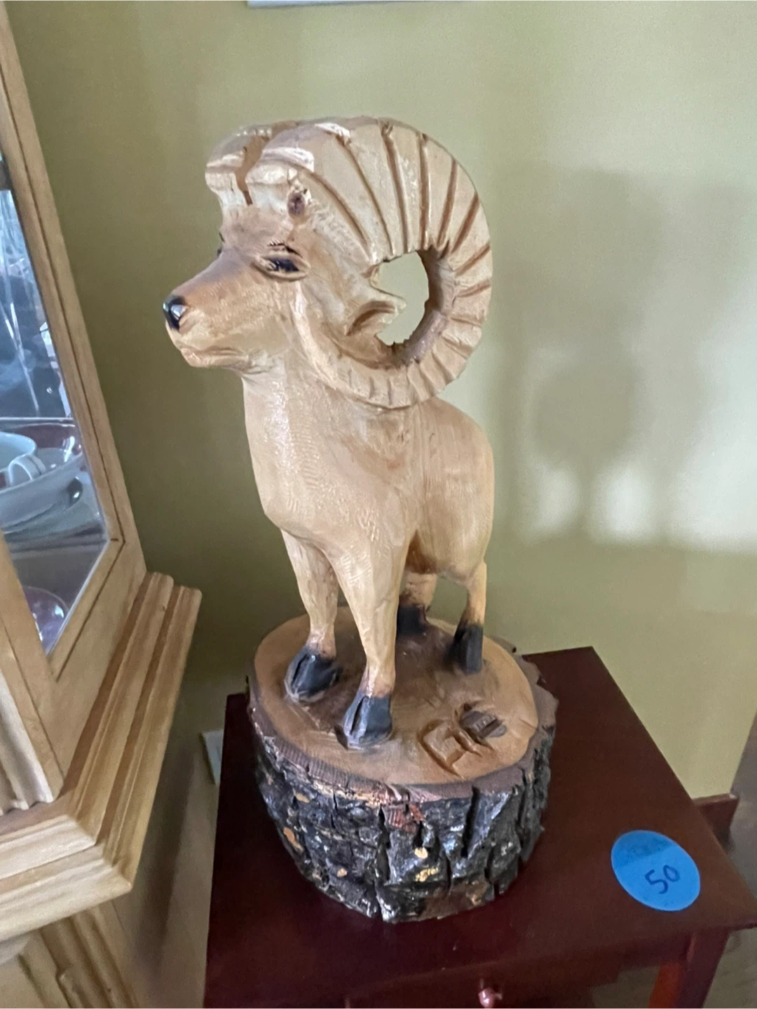 Hand-carved wooden ram statue