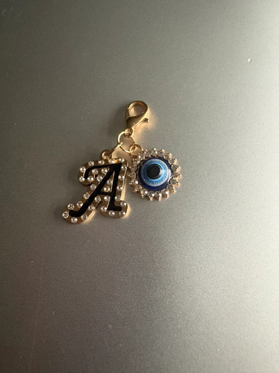 Gold tone "A" initial charm with evil eye