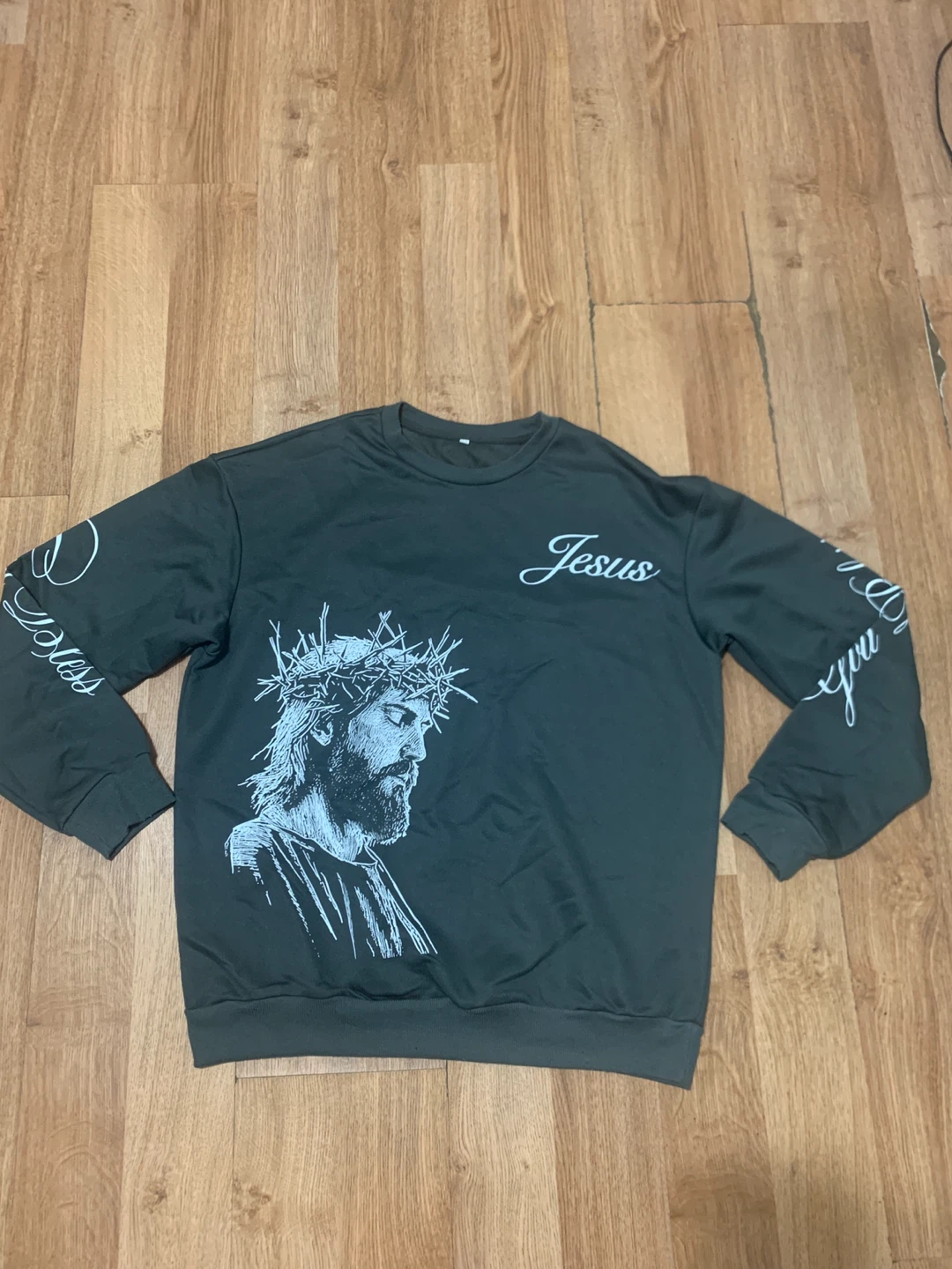 Black sweatpants with 'i fear God' text and cross graphics
