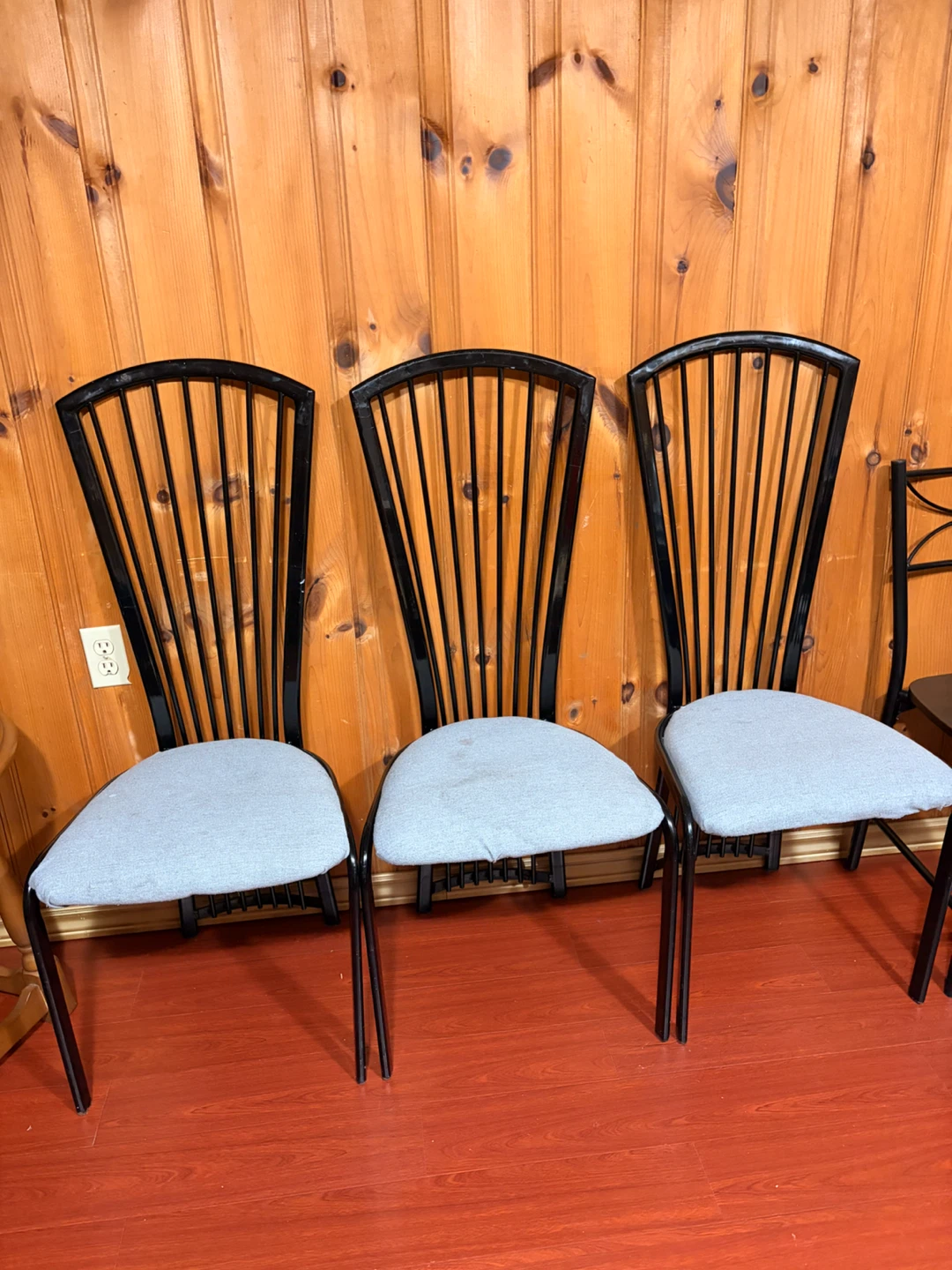 Black metal dining chairs with grey upholstered seat