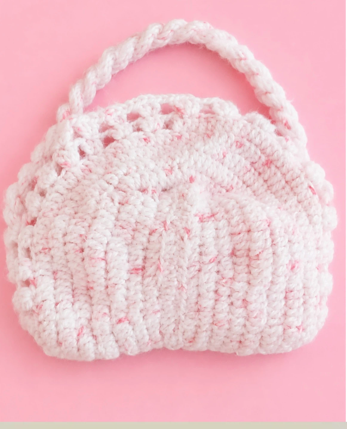 Hand-knitted pink and white purse