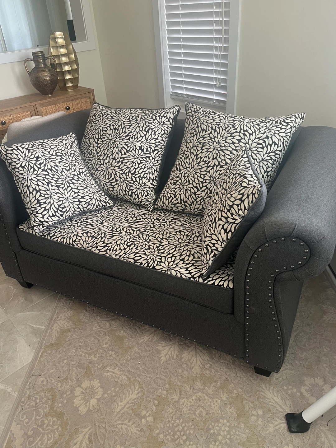 Grey Loveseat with Floral Pillows