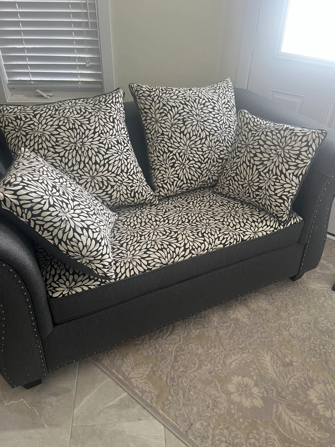 Grey Loveseat with Floral Pillows - photo 2