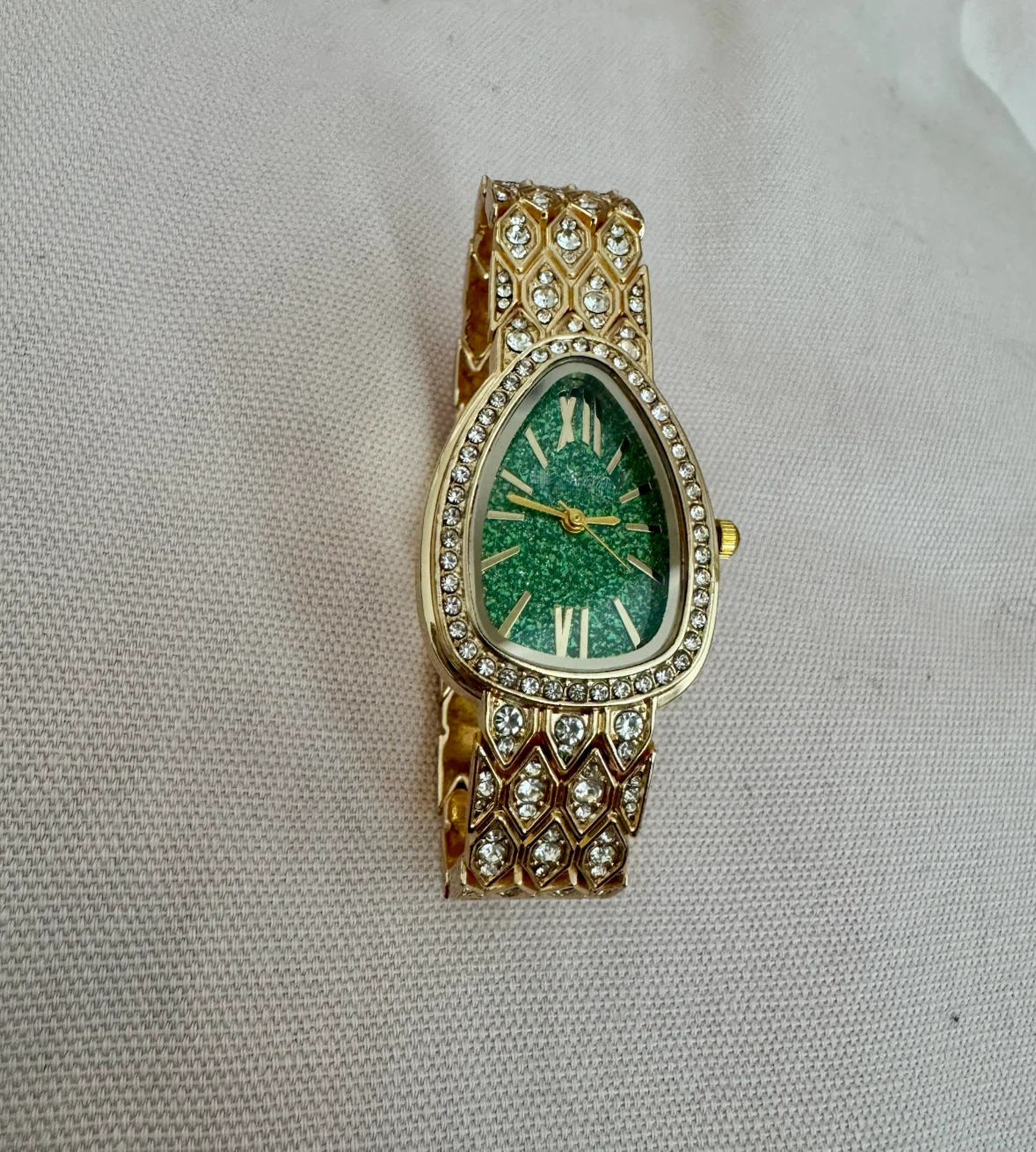 Ladies gold watch with a diamond/ Crystal bezel .
