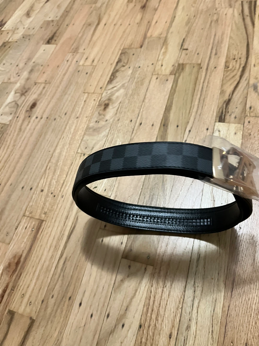 Black checkered belt with gold buckle