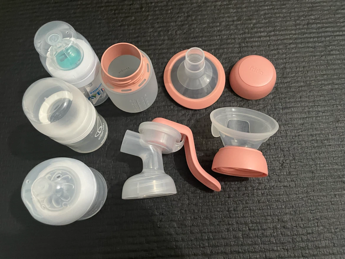 Frida Mom Breast Pump Parts with unused small bottles