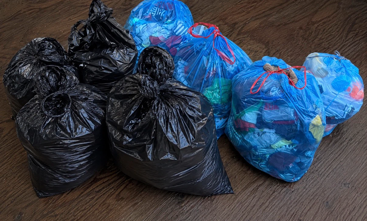 12 garbage bags full of clothes