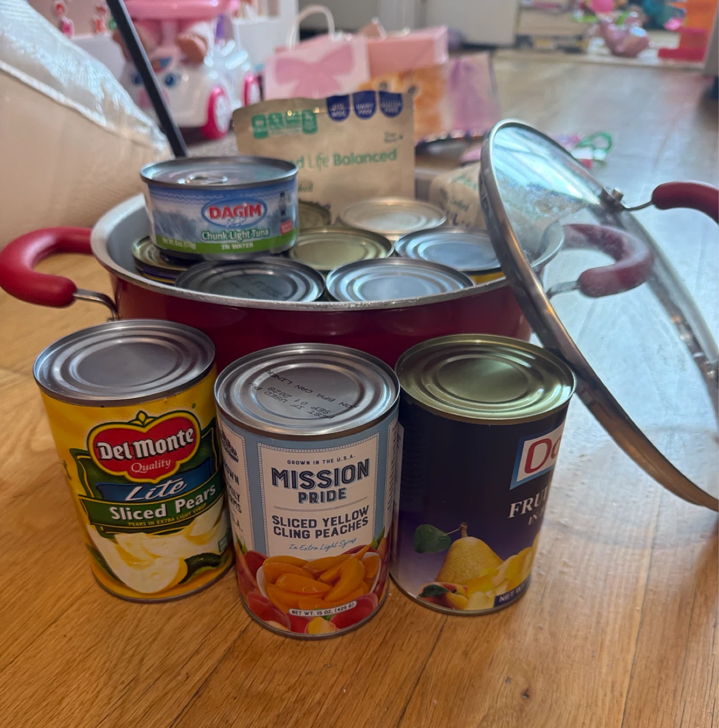 Pot with several cans of fruit