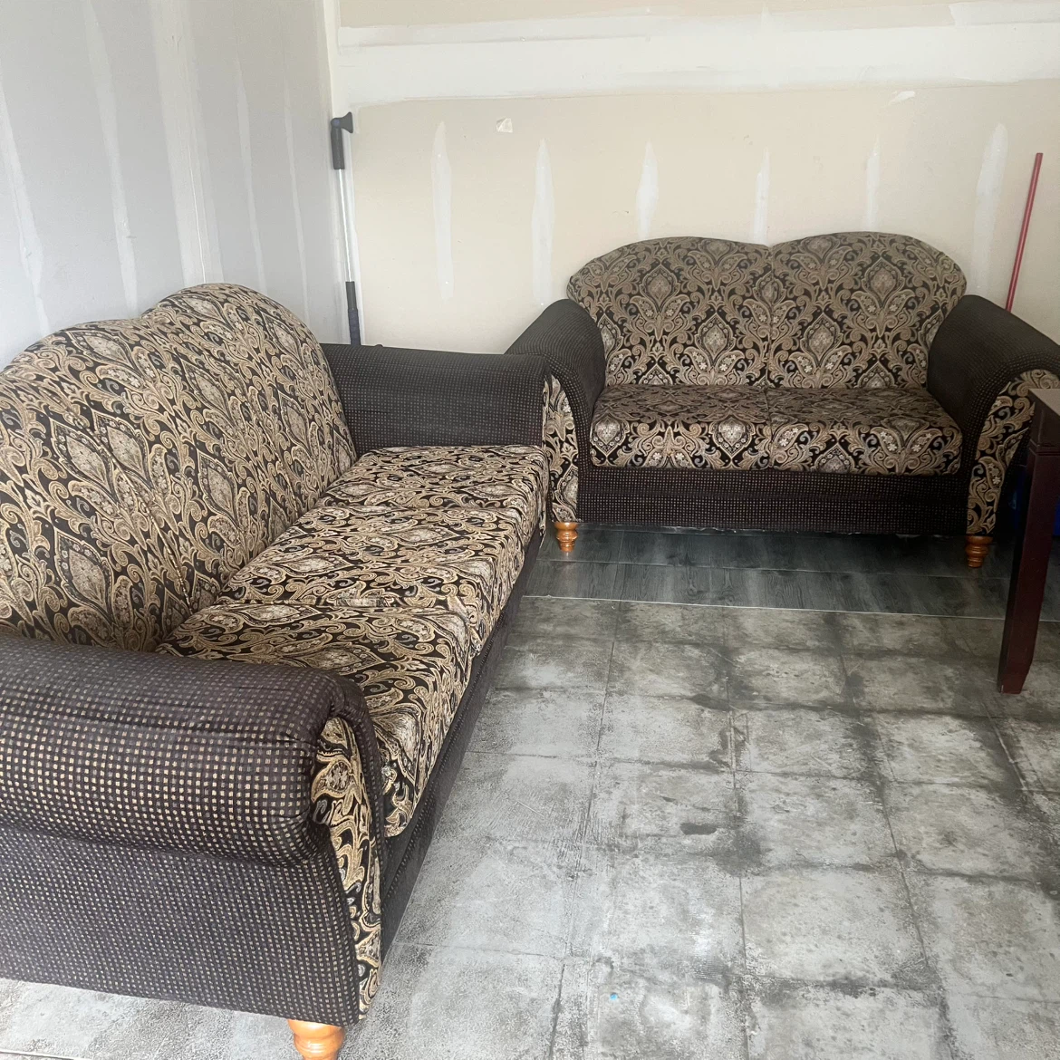 Brown and gold patterned sofa and loveseat set