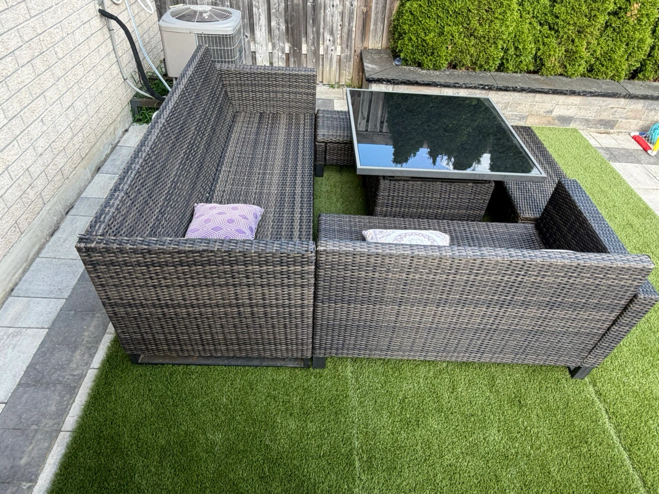 Wicker patio sectional with glass top coffee table