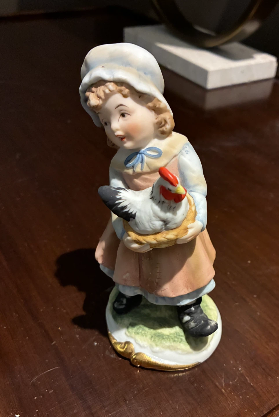Porcelain Figurine of a Girl Holding a Chicken