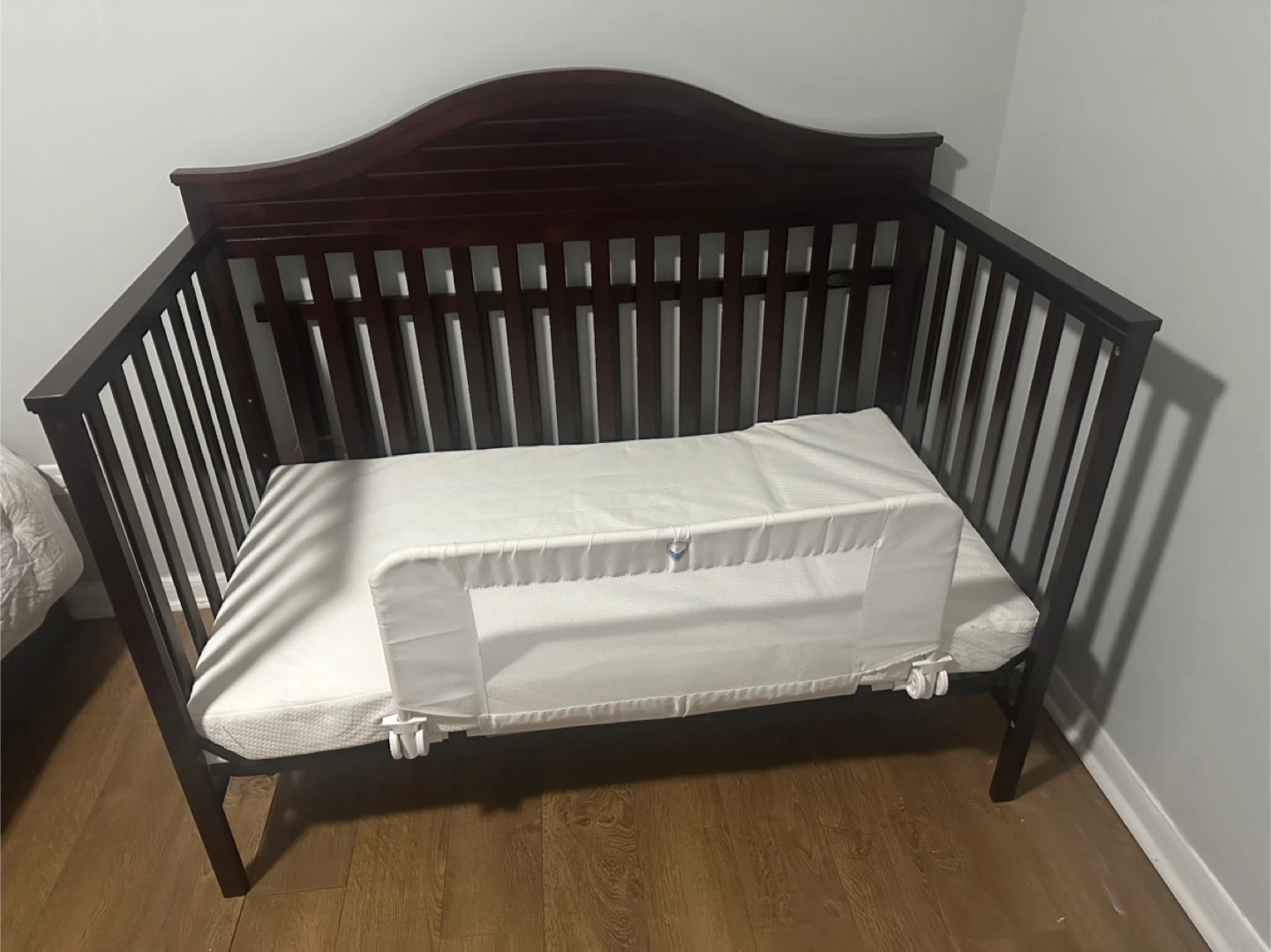 Dark Wood Crib with Toddler Guard Rail and waterproof mattress