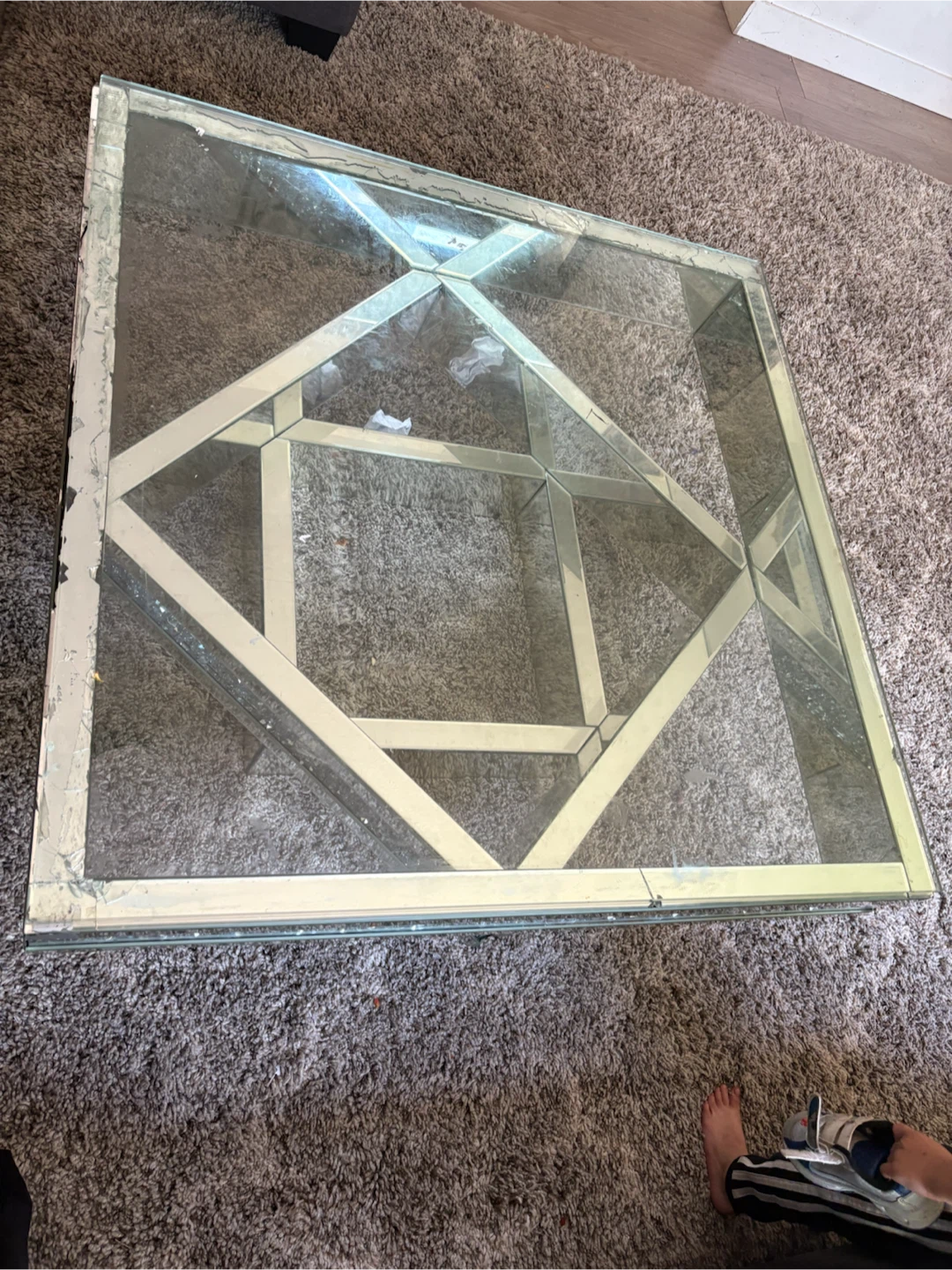 Glass coffee table with mirrored frame