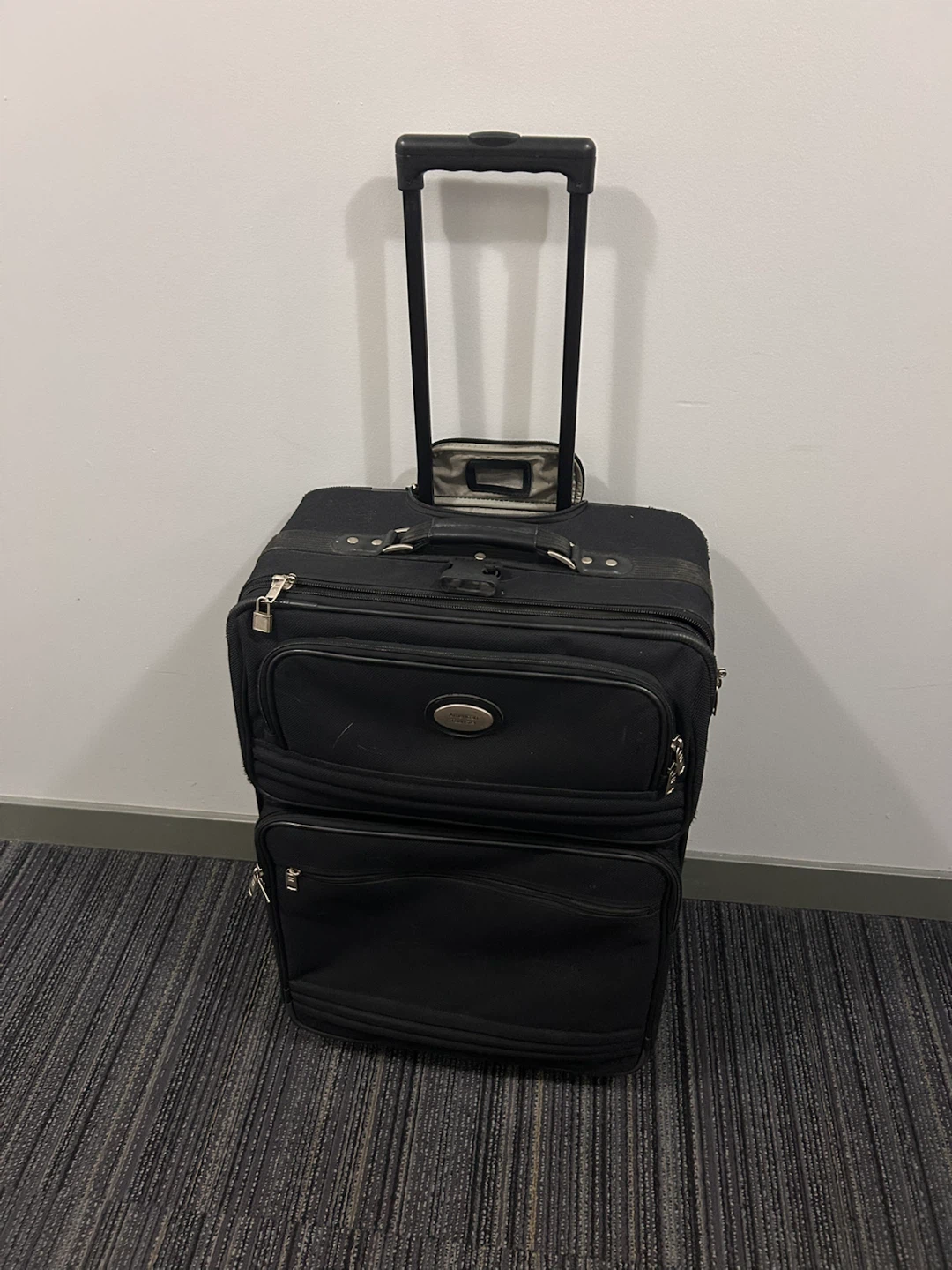 American Tourister Black Rolling Suitcase