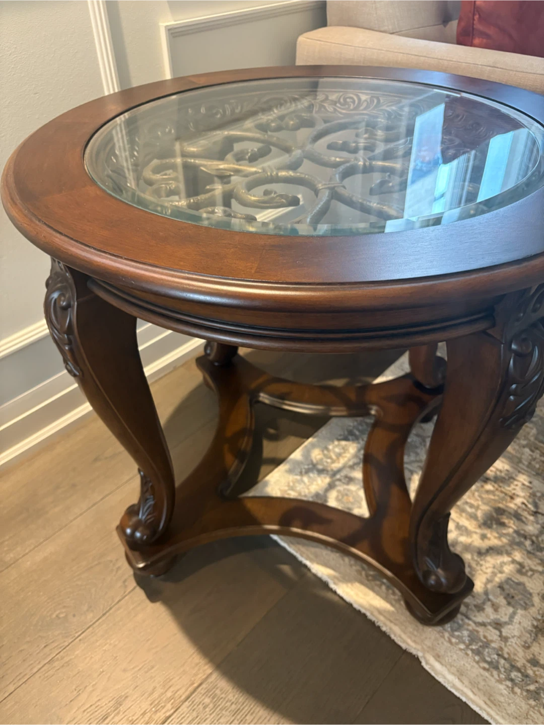 Ashley Round Wood End Table with Glass Top and Metal Scrollwork