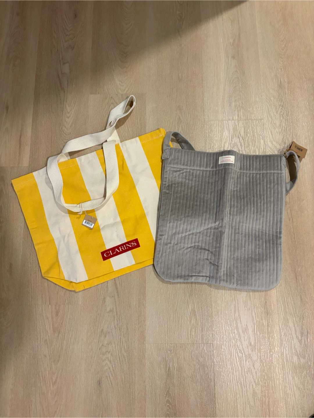 Clarins tote bag and grey bag