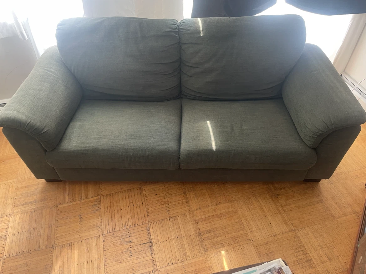 Green two-seater sofa