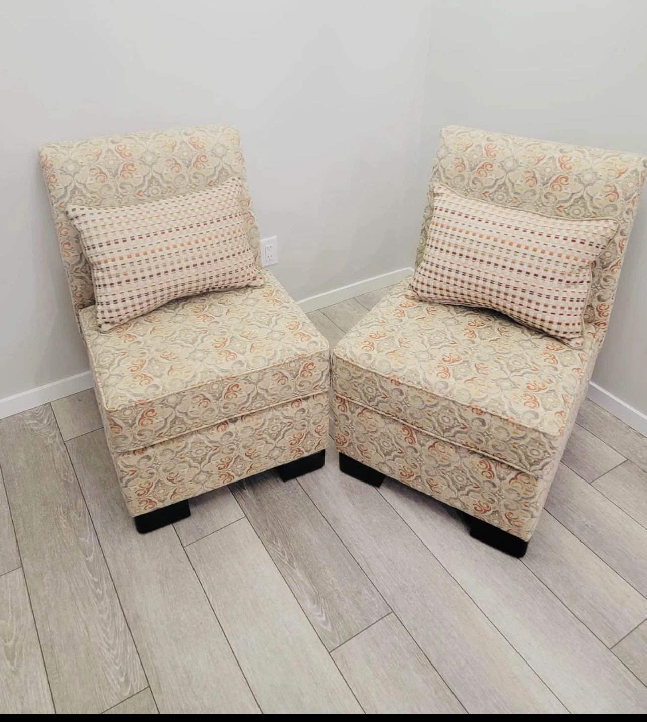 Pair of accent chairs with throw pillows