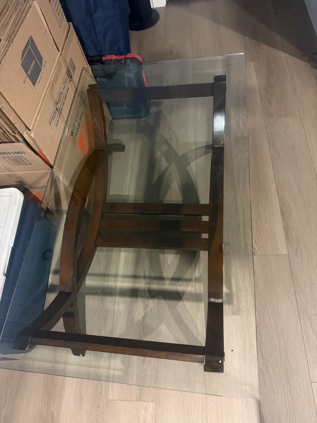 Glass top coffee table with dark wood frame