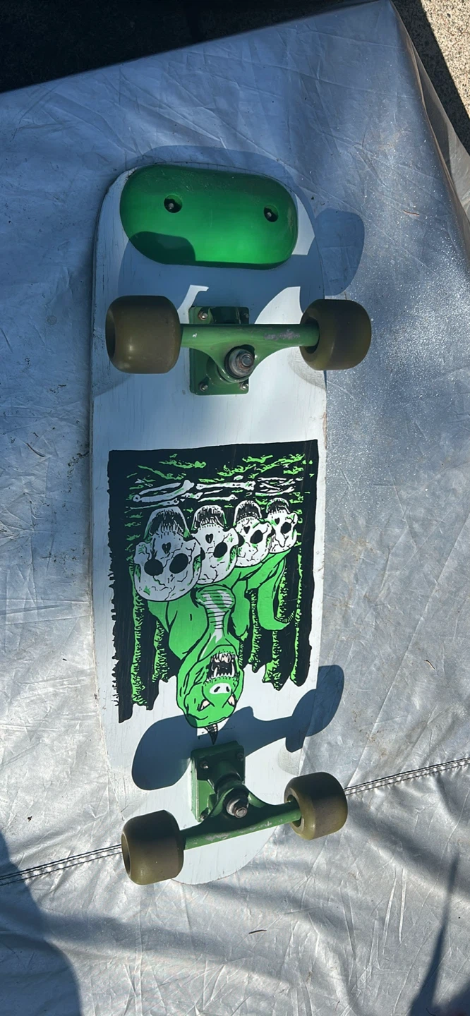 Custom Skateboard Deck with Dinosaur and Skulls Graphic