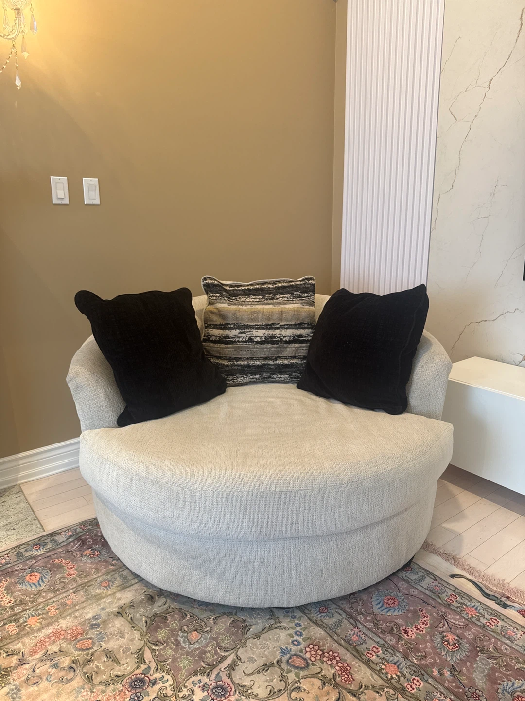 Ashly’s Cream Swivel Armchair with Black Accent Pillows