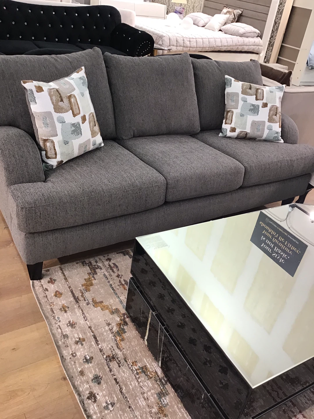 Grey Three-Seater Sofa with Decorative Pillows