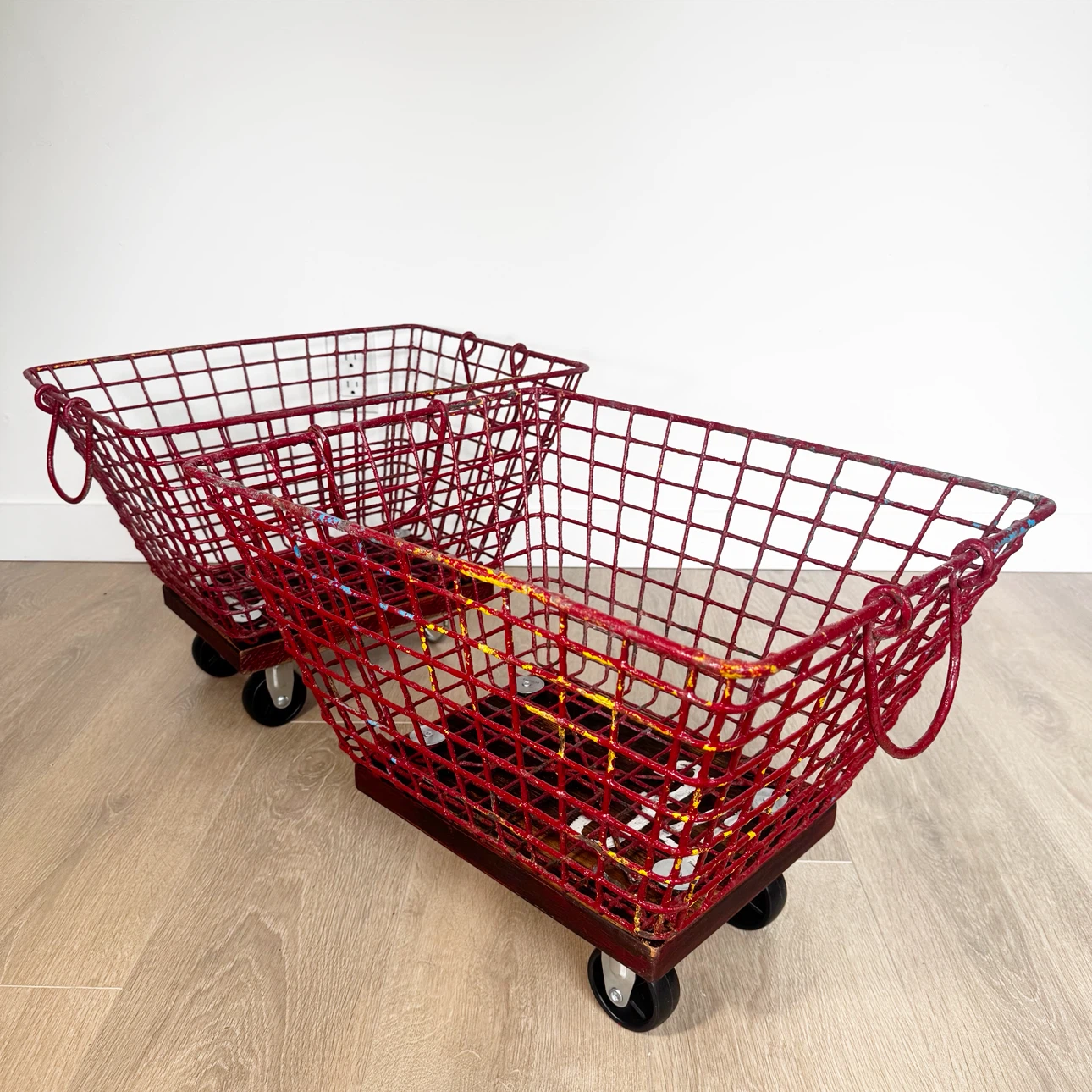 Pair of vintage industrial gym locker baskets on wheels