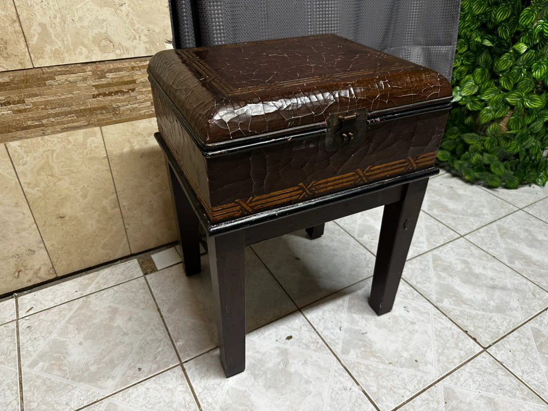 Dark wooden storage chest with a rustic, textured finish