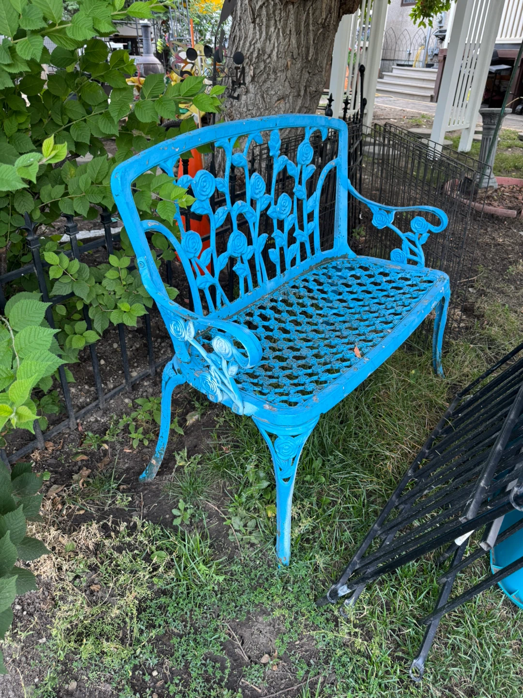 Blue metal garden bench with rose design