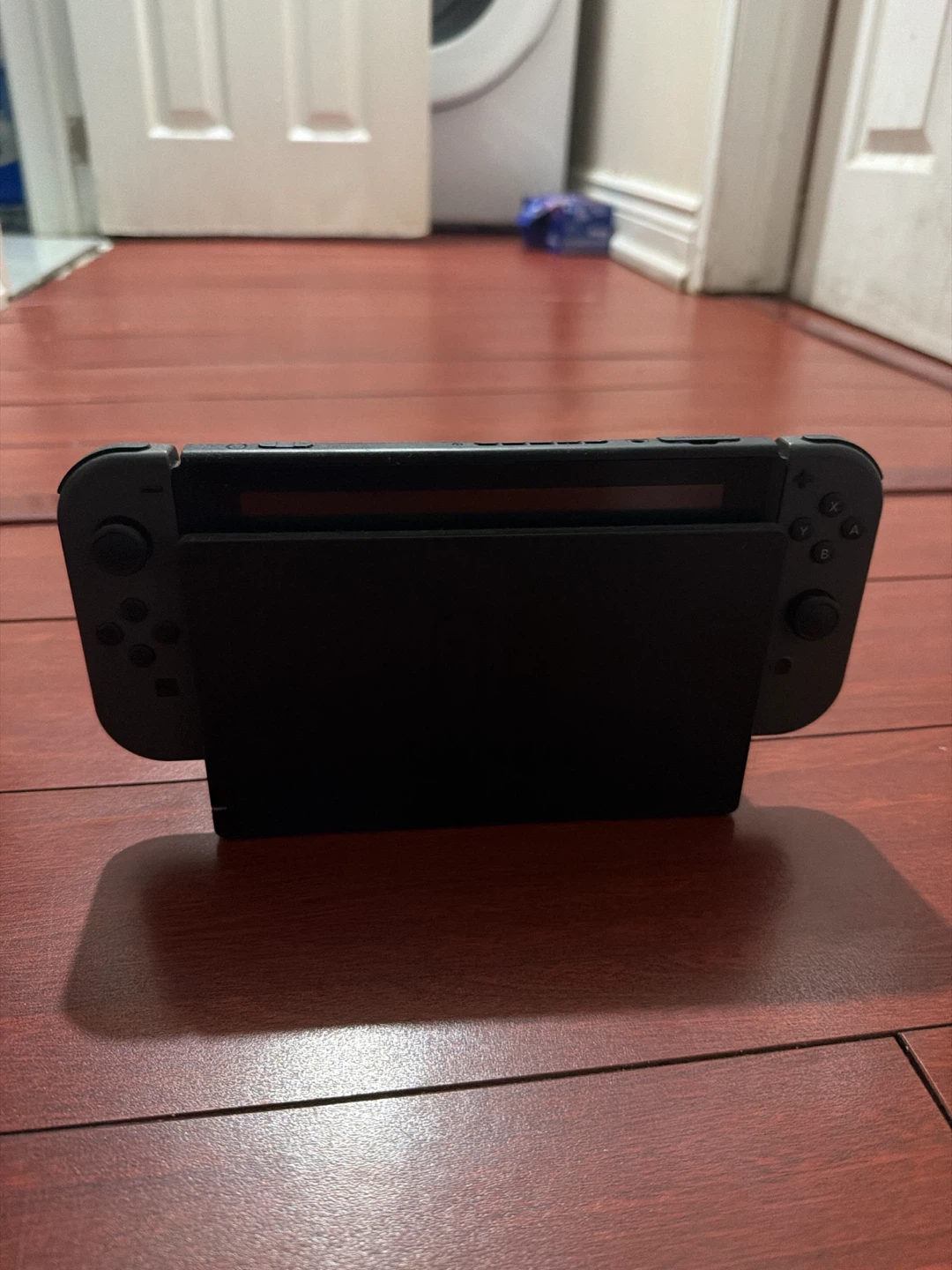 Nintendo Switch console with Grey Joy-Cons and dock