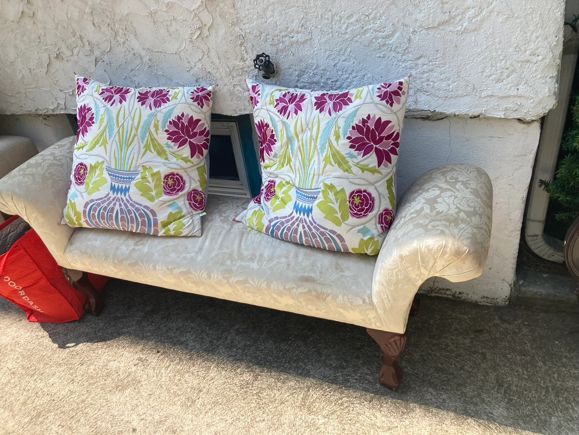 Cream Upholstered Chaise Lounge with Decorative Pillows