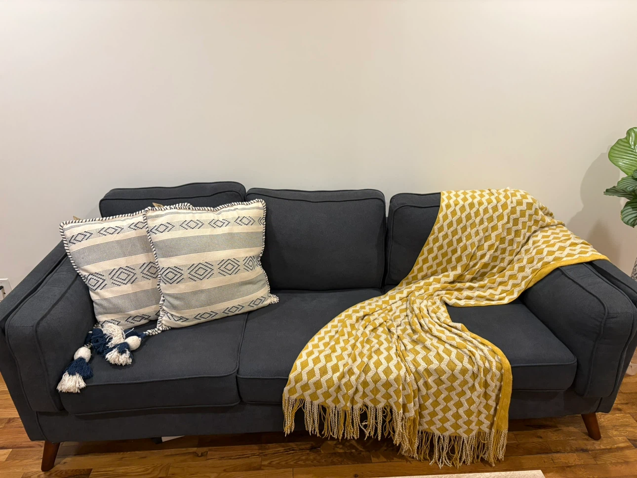 Dark Gray Sofa with Decorative Pillows and Yellow Throw Blanket