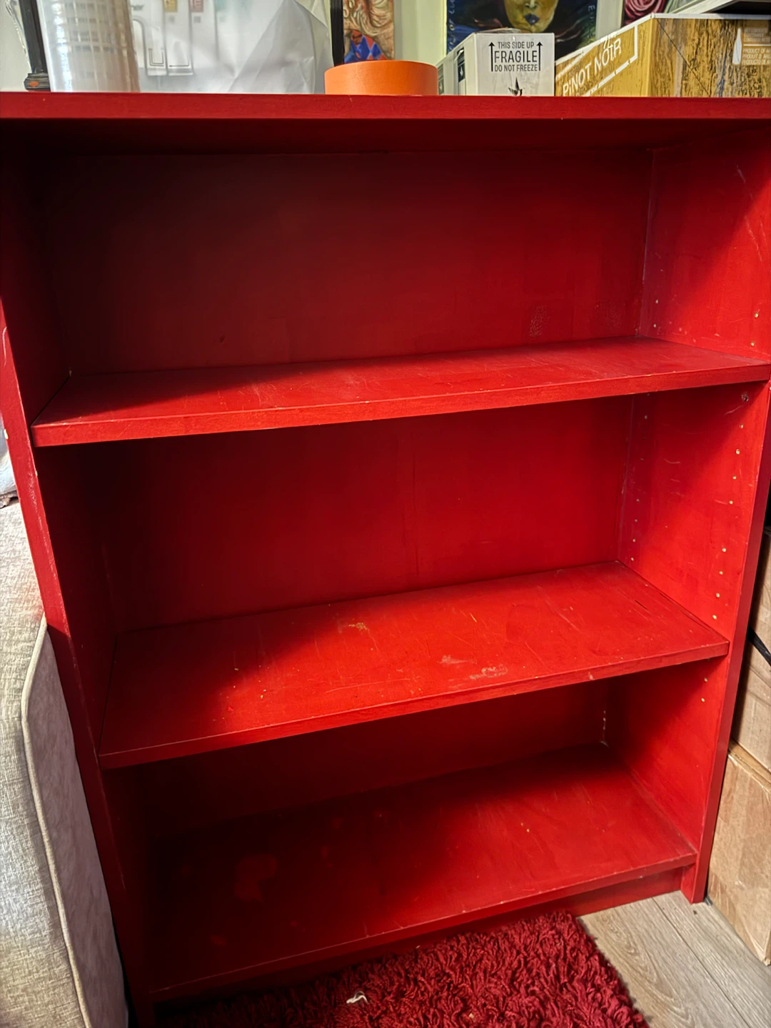 small red wood bookshelf