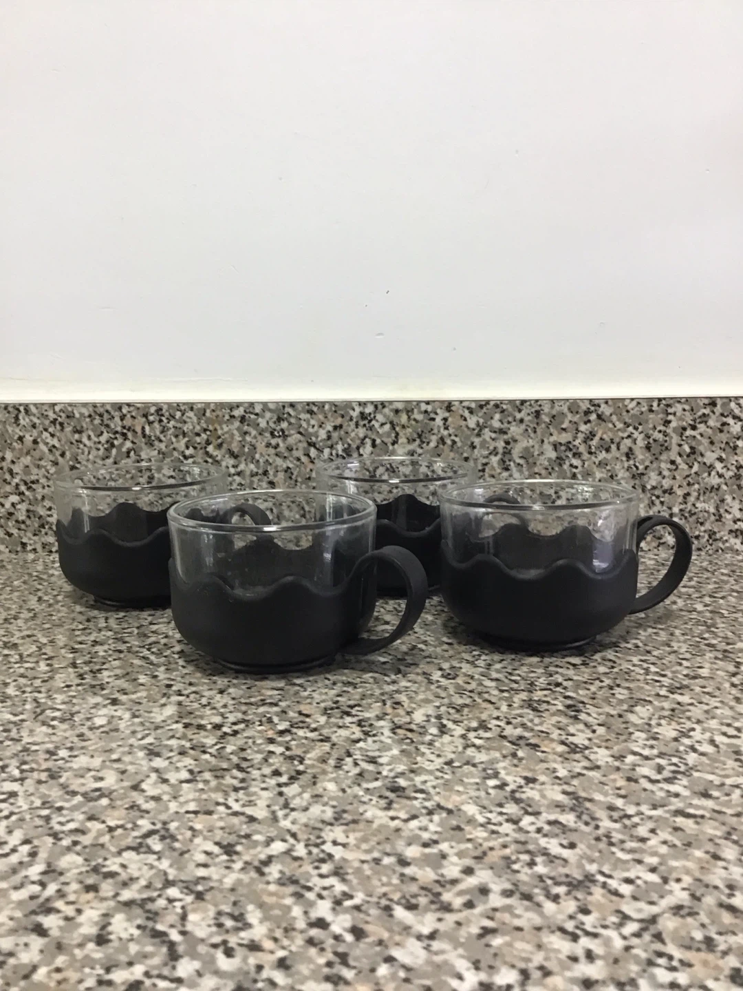 Set of 4 Clear Glass Mugs with Black Grips