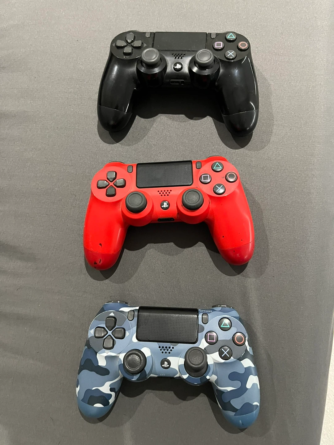 3x PlayStation 4 Controllers (Black, Red, Camo)